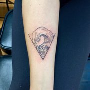 Wave tattoo with water alchemy symbol
