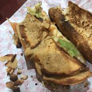 a half eaten sandwich on a piece of paper