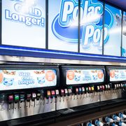 a row of soda machines in a store