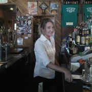 a woman behind the bar