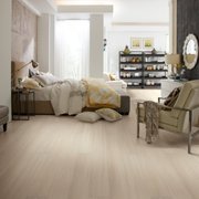 a bedroom with a bed and a chair