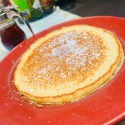 a pancake on a red plate