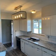  kitchen with white cabinets and granite countertops