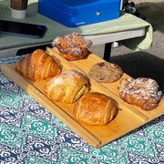 a variety of pastries on a wooden tray