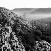 As they enter the valley, shadows and fog play in the arena between nature's plateaus - North and South Table Mountain in Oroville, CA, USA.