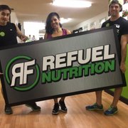two people holding a refuel nutrition sign