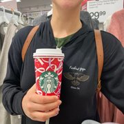 a woman holding a cup of coffee