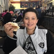 Plain bagel with cream cheese enjoyed by this cool kid.