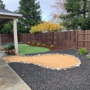 a backyard with a gravel path