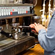 a woman using a coffee machine