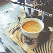 a cup of coffee on a coffee machine