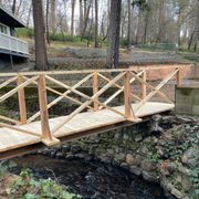 a wooden bridge over a stream