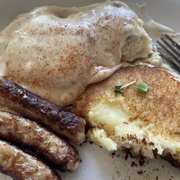 Biscuits and gravy with a potato pancake.