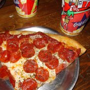 Best pizza in the world, and I've been around the world! That's 1 slice next to 2 big-ass cokes! Only thing beet would be 2 slices!