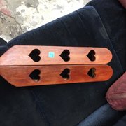Handmade solid wood cabinet with hearts carved into the doors.