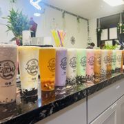 a variety of drinks lined up on a counter