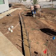 a backyard with a concrete fence