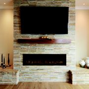 For added flair, our client commissioned a fireplace that doubled as an entertainment center.