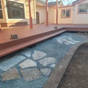 Finished repairing this deck, stained, and set up this flagstone walkway to the preexisting concrete border.