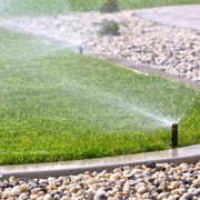 a sprinkler spraying water on a lawn