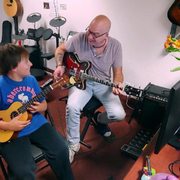 In the middle of a guitar lesson with Eric Pytryga, Director of the Apollo Academy of Music.
