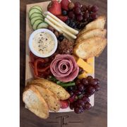 a platter of meat, cheese, fruit, and bread