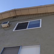 Loose electrical cable hangout on side of building