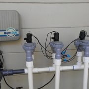 a number of pipes connected to a water meter