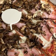 a pizza with mushrooms and ham