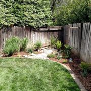 a backyard with a wooden fence