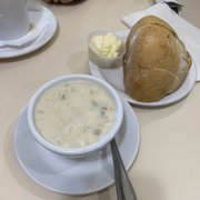 Clam chowder, tasty warm bread.