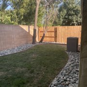 a backyard with a fence and grass