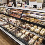 a display case of cakes and pastries
