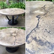 Round concrete table with black iron base.