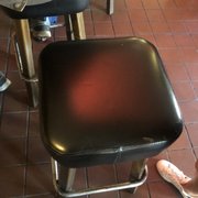 a black stool and a pair of pink shoes