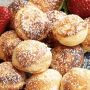 strawberries and powdered sugar covered donuts