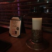 a candle and menu on a table
