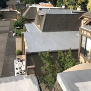 Combined roofing of Silicone Coating and Composition Shingles.