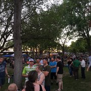 a crowd of people walking around a park
