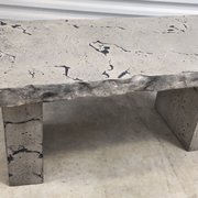 Grey and black concrete bench with hand chiseled edges.