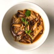 a bowl of stew with mushrooms