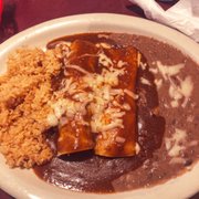 Cheese and chicken enchilada with rice and beans.
