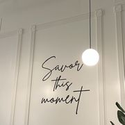a sign that says savor this moment