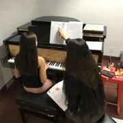 In the middle of an in-depth lesson with Enid Gonzalez, one of our foremost piano instructors.