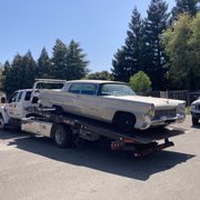 1958 Lincoln Premier.. 19ft long 80 inches wide and low to the ground.   If you make the call he can haul it all !!