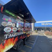a taqueria truck parked in front of a walmart store