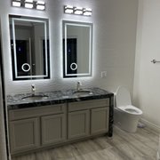 a bathroom with two sinks and a toilet