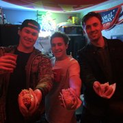 Owner Sam Hecker (in the middle) serves up 3 fresh Glizzies to 2 customer's