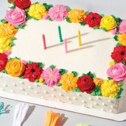 a cake decorated with flowers and candles