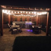 a patio with a table and chairs